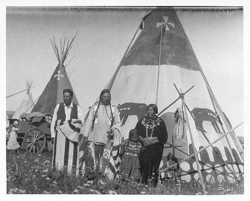 A black and white photo of painted tipi.