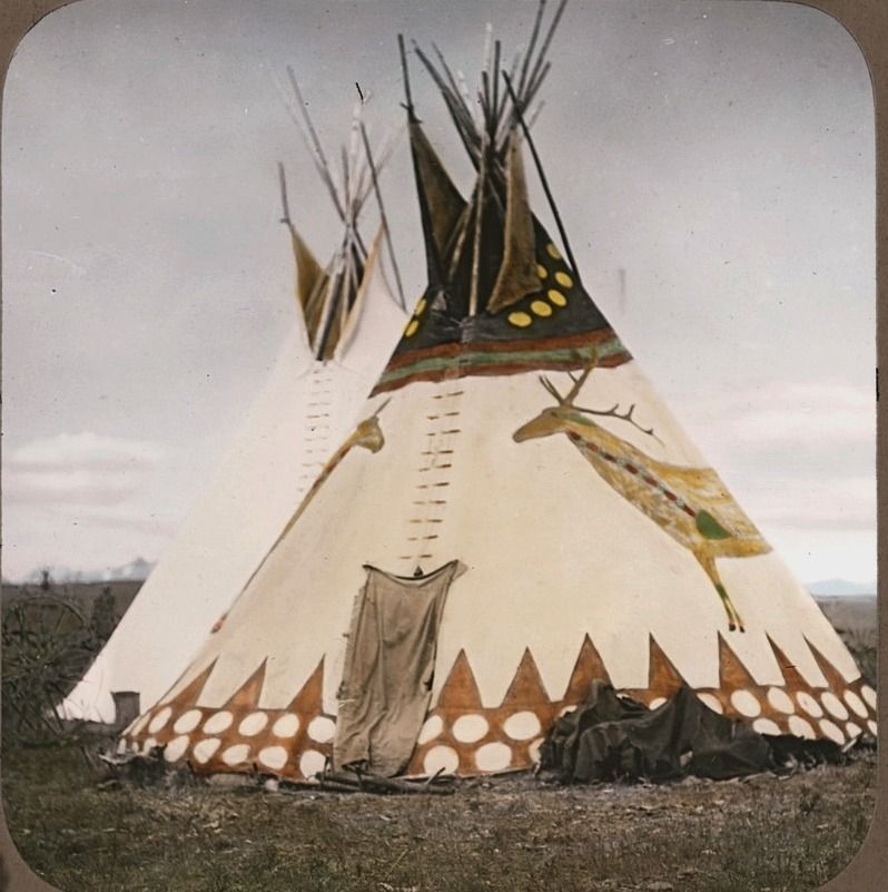 An archival photo in colour of a tipi with painted canvas.