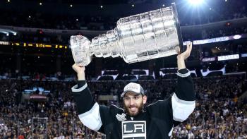 Dwight King holds the Stanley Cup over his head.