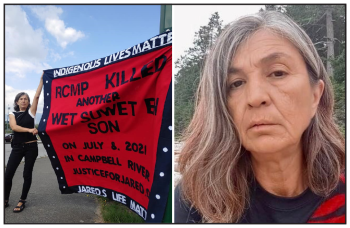 A woman holds up a button blanket with the words: Indigenous Lives Matter. RCMP killed another Wet’suwet’en Son on July 8, 2021 in Campbell River. JusticeforJared.org