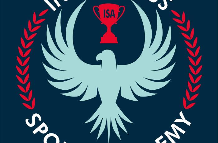 The logo for the Indigenous Sports Academy shows a blue bird with its wings spread out and up with a red trophy above its head.