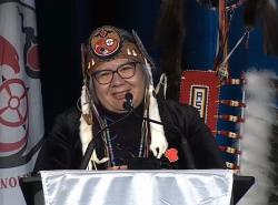 National Chief RoseAnne Archibald at podium smiling