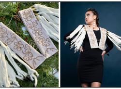 A shawl that looks like two narrow white panels that are connected by strings of crystals are decorated with long ermine pelts at the shoulders. At right a woman models the shawl twirling her upper body to make the ermine pelts swing.