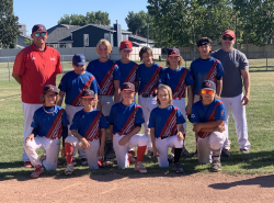 A typical team shot of a young Métis baseball team on the field posing for the camera.