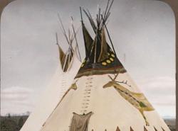 An archival photo in colour of a tipi with painted canvas.