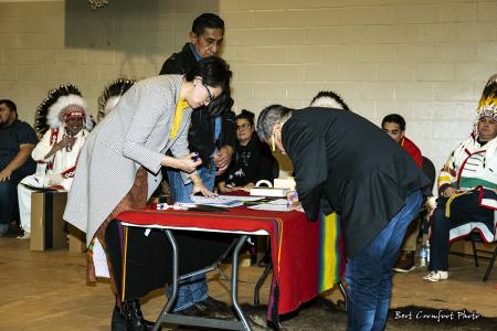 Councillor Wade Healy signs official documents