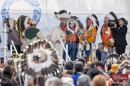 Dr. Wilton Littlechild places a headdress on Pope Francis after his apology